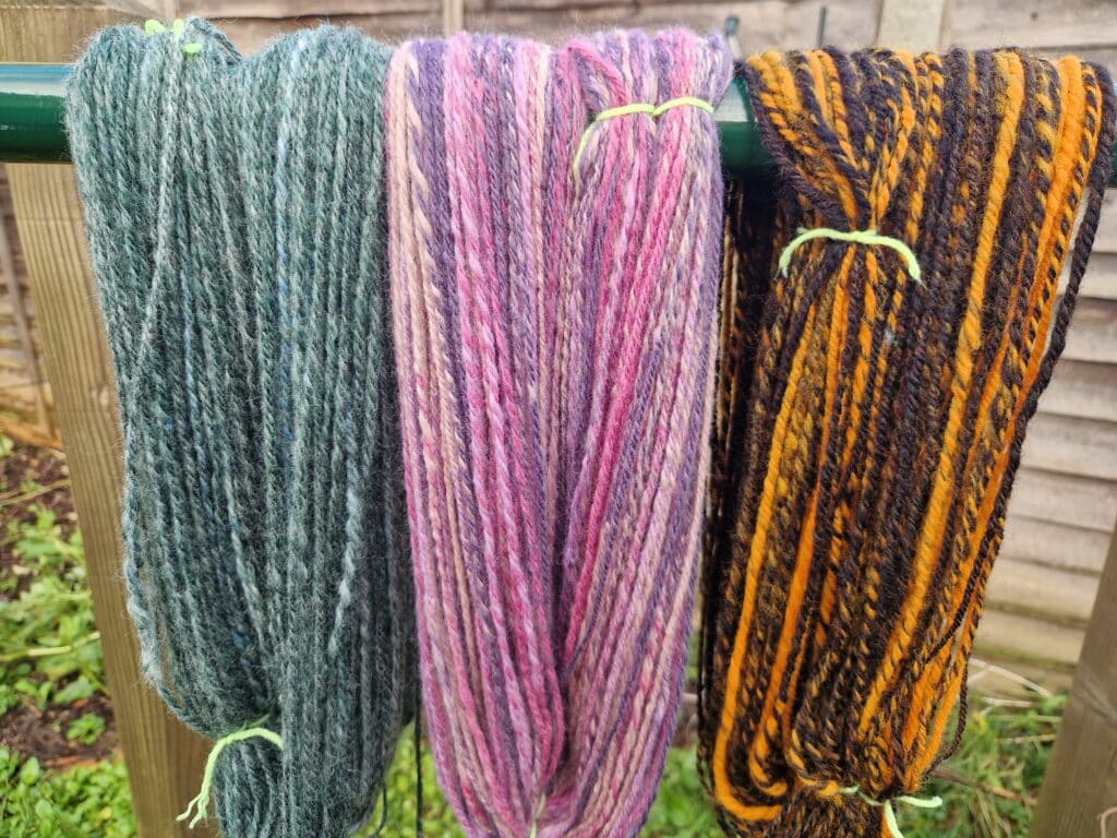 Spinning wheel spun yarns. Chain plied.