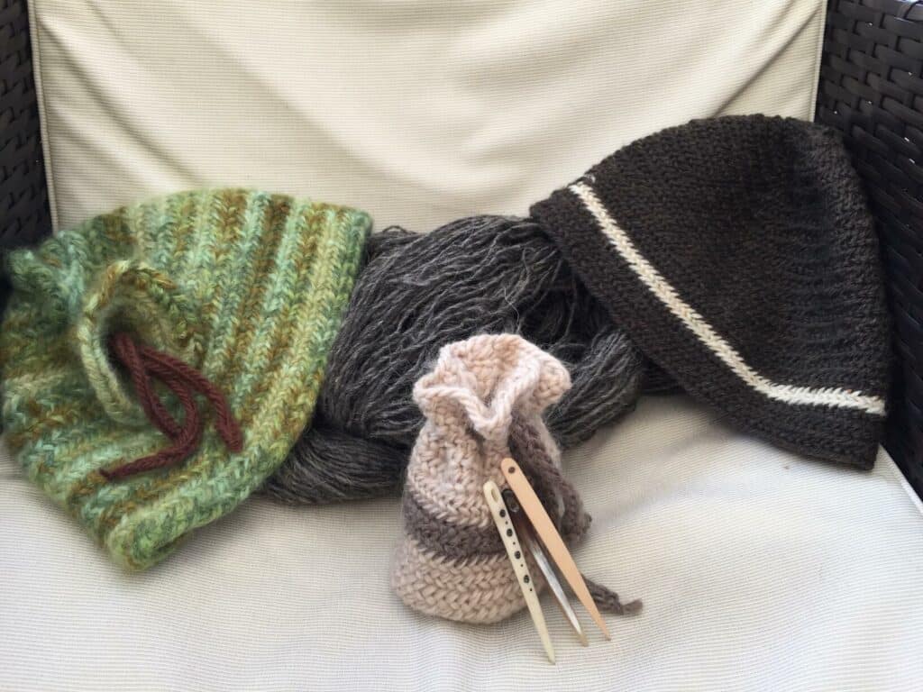 Nalebinding hats, small pouch, handspun wool examples.