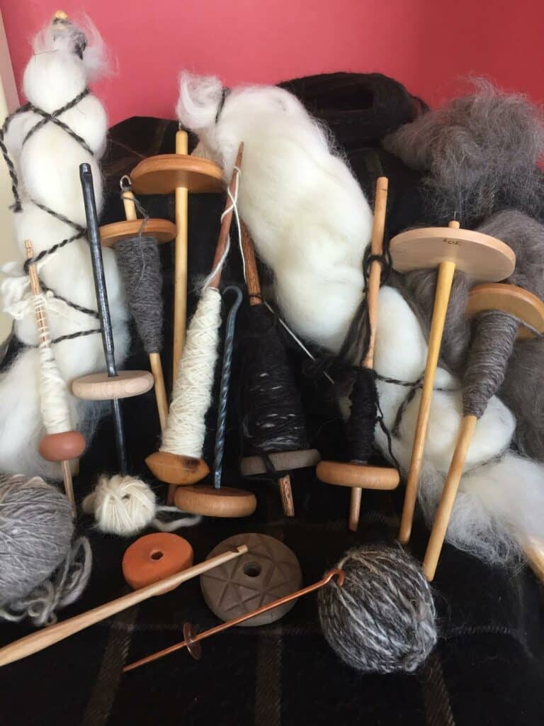 Hand spinning with a variety of historic drop spindles