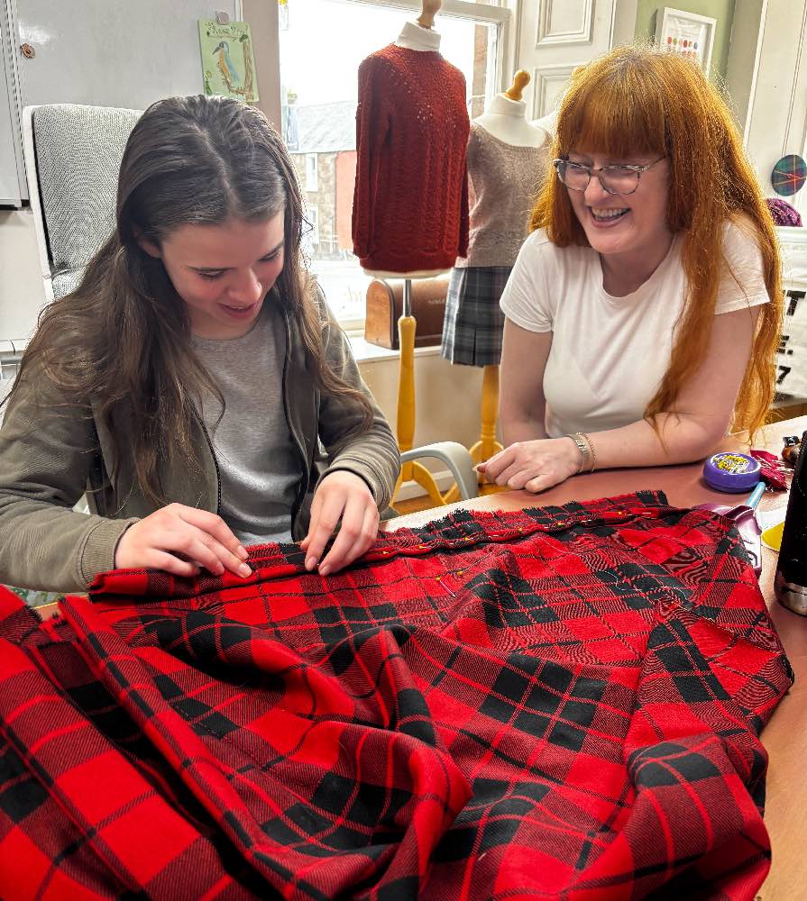 Headteacher and Master Kiltmaker Siobhan teaching Saturday Club member Myka