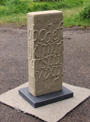 Standing stone alphabet in York sandstone