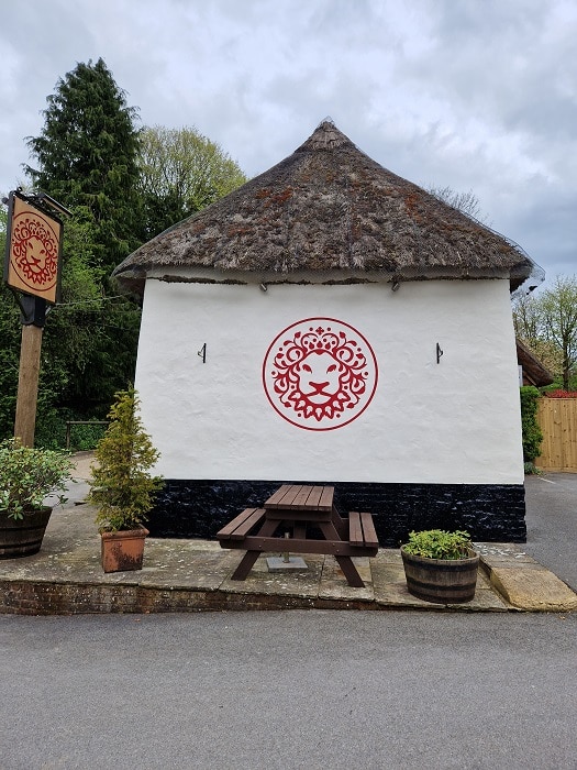 New logo hand painted on a pub end wall after rebranding