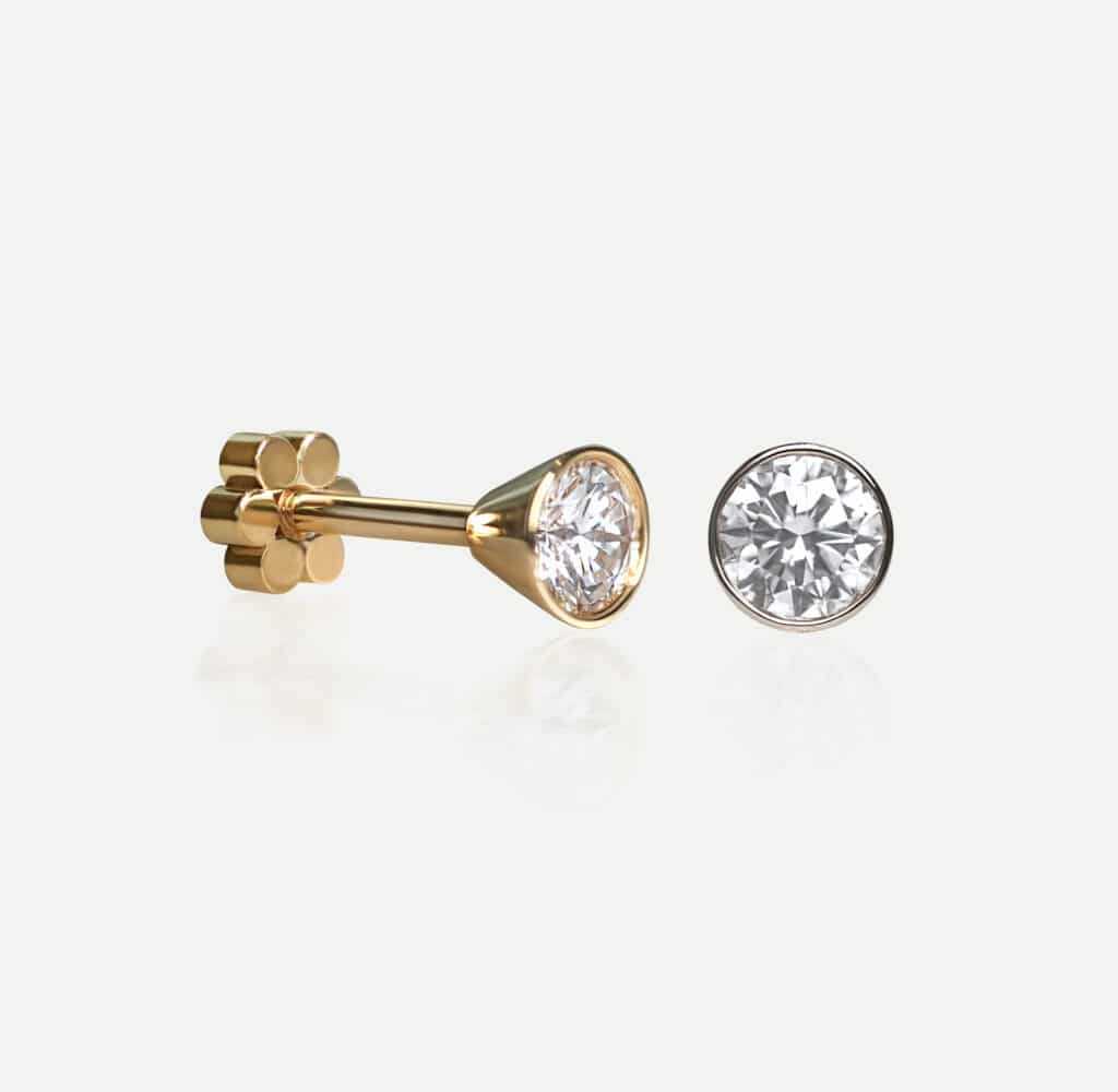 Natural diamond piercing stud earrings in 18K solid gold. Handcrafted minimalist jewellery by Lena Cohen Jewellery London, screw-back secure fine piercing design.