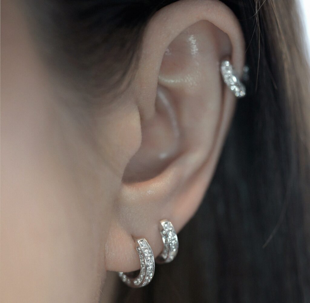 Curated ear with diamond hoop earrings in 18K solid gold. Lena Cohen Jewellery London.