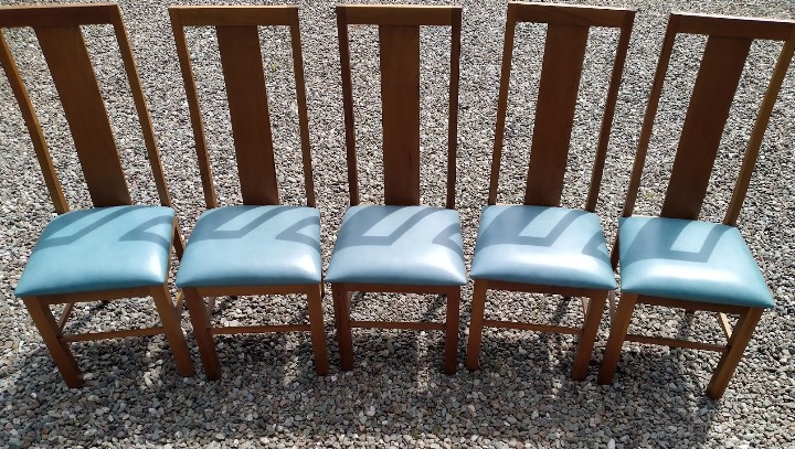 A set of dining chairs stripped, refinished and reupholstered in leather.