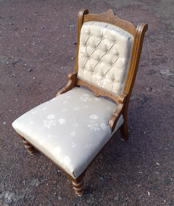 An antique nursing chair with deep buttoning to the back. We restored and reupholstered this for a customer in Edinburgh.
