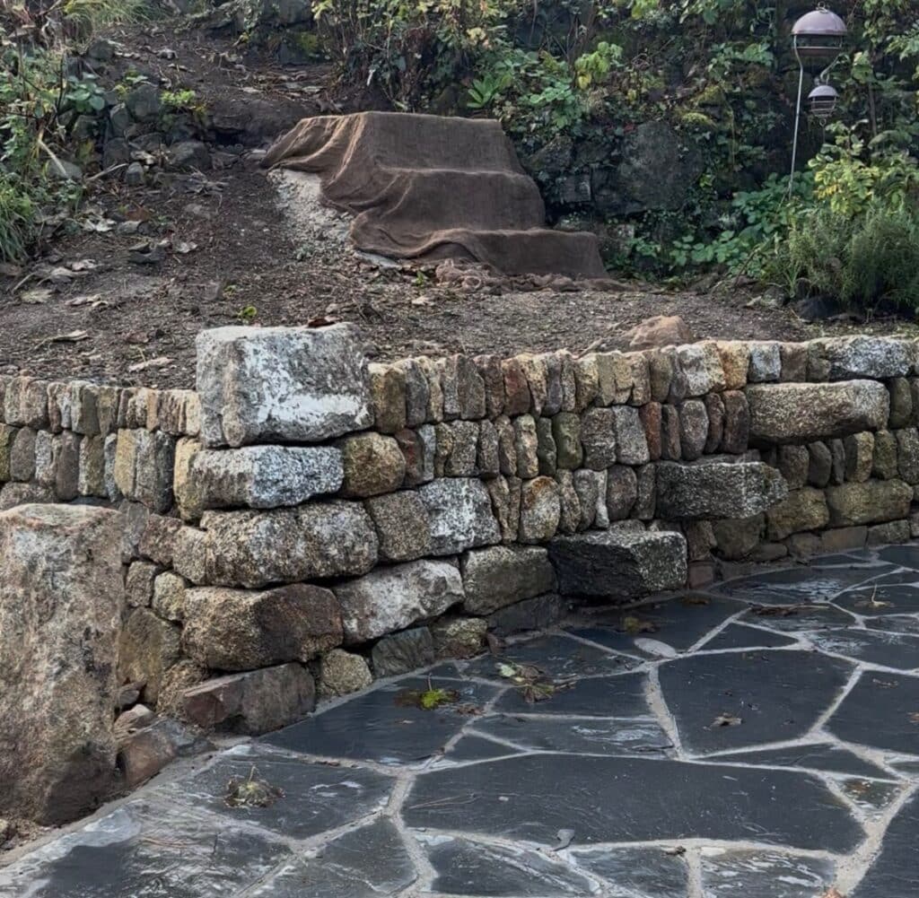 Dressed granite retaining hedge with gamekeeper stile in St Ives, Cornwall